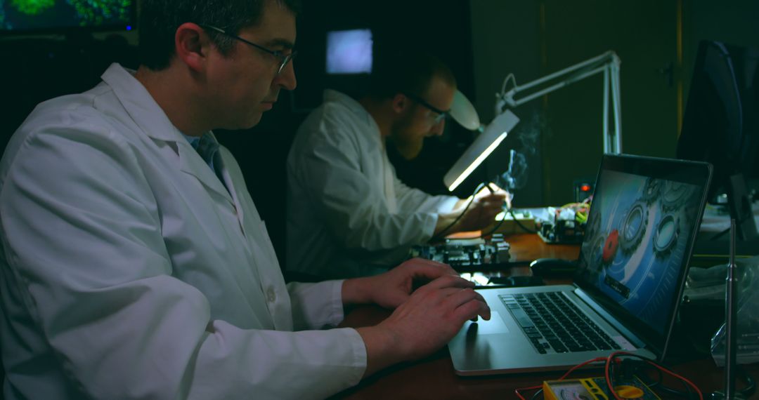 Scientists in Laboratory Working on Electronics and Computer - Free Images, Stock Photos and Pictures on Pikwizard.com