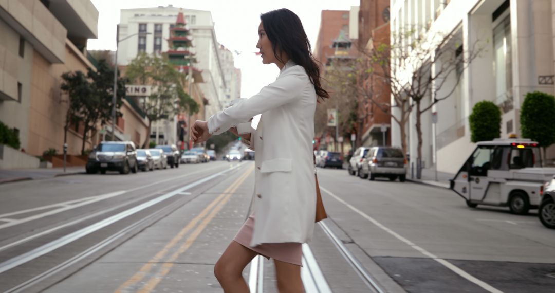 Businesswoman Checking Time While Crossing Street - Free Images, Stock Photos and Pictures on Pikwizard.com