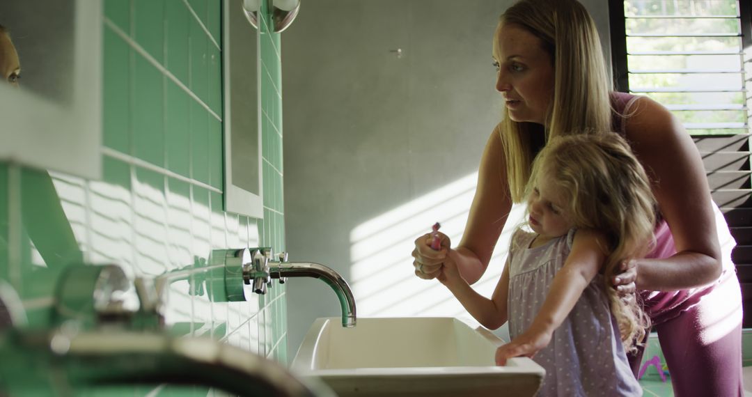 Mother and Daughter Brushing Teeth in Modern Bathroom - Free Images, Stock Photos and Pictures on Pikwizard.com