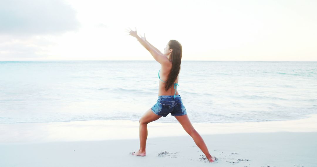 Woman Practicing Yoga on Ocean Beach at Sunrise - Free Images, Stock Photos and Pictures on Pikwizard.com