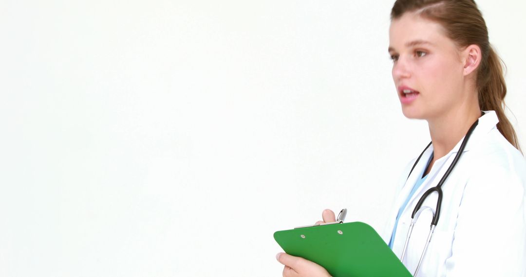A young Caucasian female doctor is holding a clipboard, with copy space - Free Images, Stock Photos and Pictures on Pikwizard.com