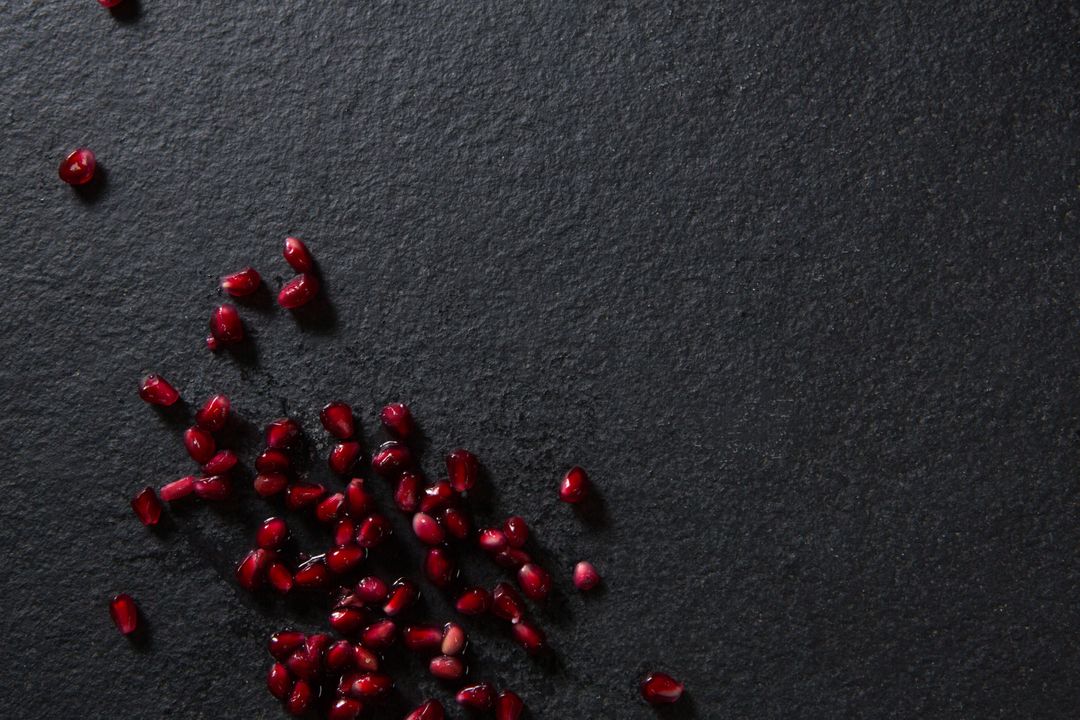 Pomegranate Seeds on Dark Slate Background - Free Images, Stock Photos and Pictures on Pikwizard.com