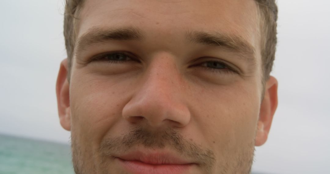 Close-up Portrait of Smiling Man at Beach