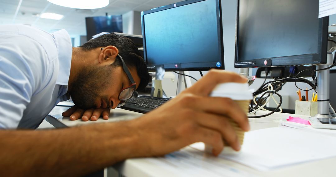 Exhausted Office Worker Resting at Busy Workspace
