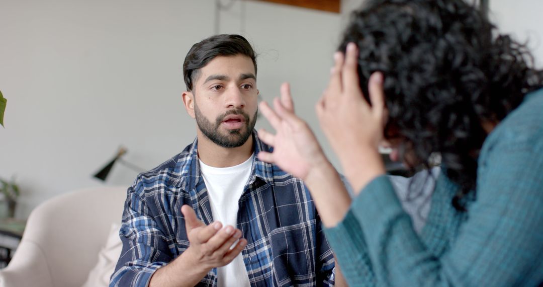 Frustrated Couple Arguing on Sofa at Home