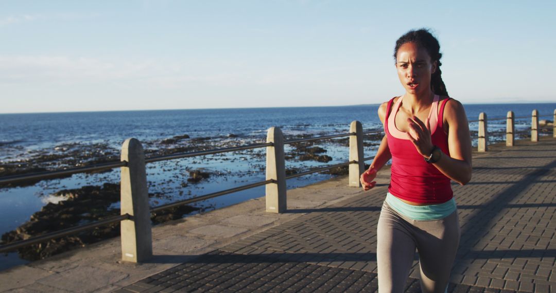 Determined Woman Jogging along Seaside Promenade at Sunrise - Free Images, Stock Photos and Pictures on Pikwizard.com