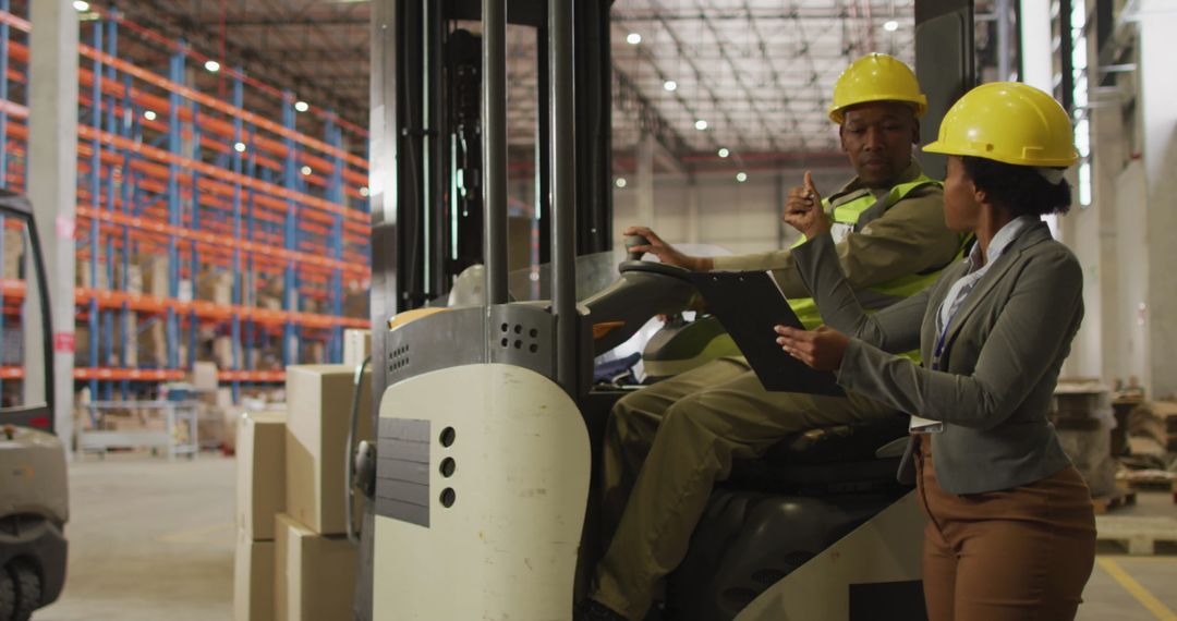 Warehouse Workers Discussing Safety Protocols with Forklift