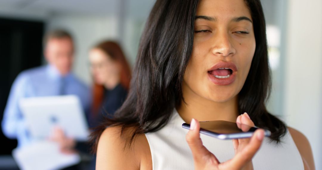 Woman Utilizing Voice Assistant Technology in Office Setting