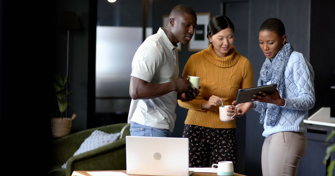 Diverse Team Cooperating on Digital Projects in Modern Office