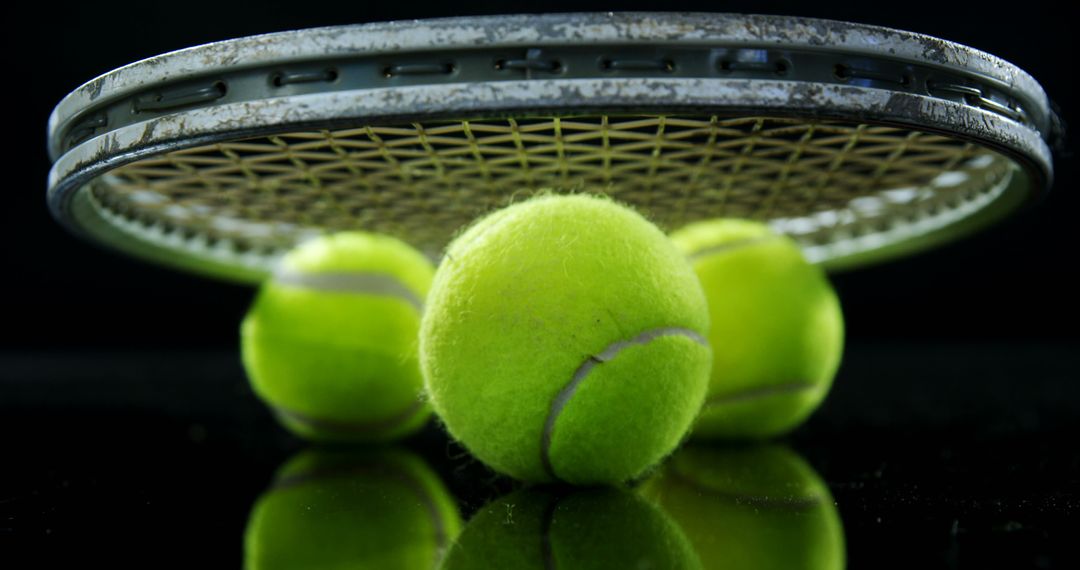 Close-Up of Tennis Racket and Balls on Black Background - Free Images, Stock Photos and Pictures on Pikwizard.com