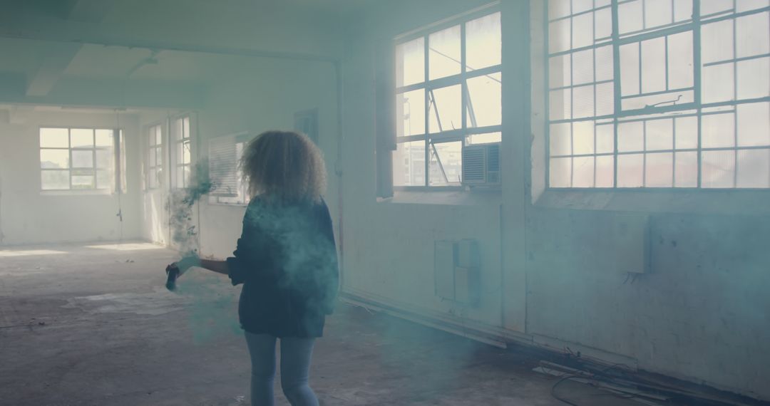 Caucasian Woman Exploring Smoky Abandoned Building