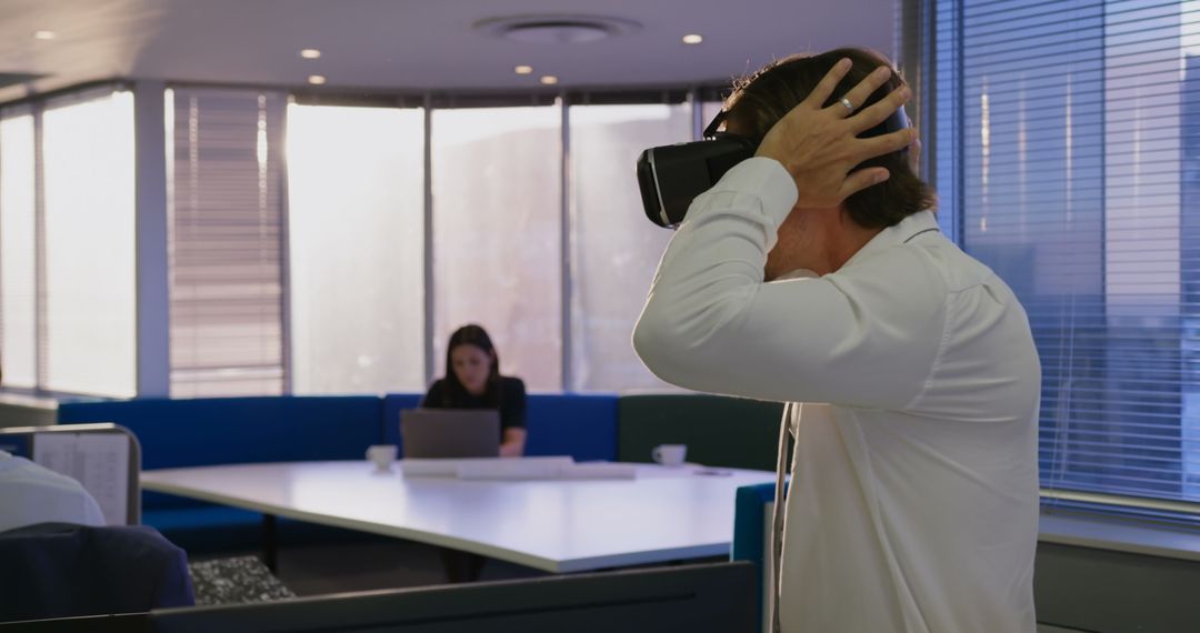 Caucasian Male Executive Using VR Headset in Modern Office