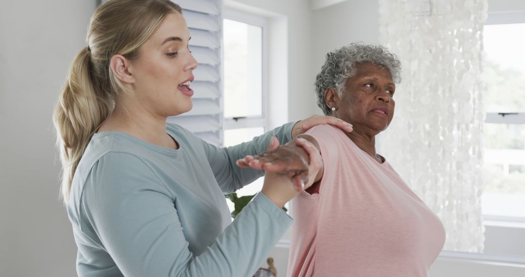 Physiotherapist Assisting Elderly Woman with Arm Rehabilitation Exercises - Free Images, Stock Photos and Pictures on Pikwizard.com