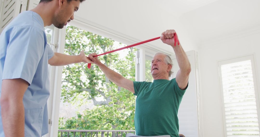 Senior Man Working with Physical Therapist Using Resistance Band for Rehabilitation - Free Images, Stock Photos and Pictures on Pikwizard.com