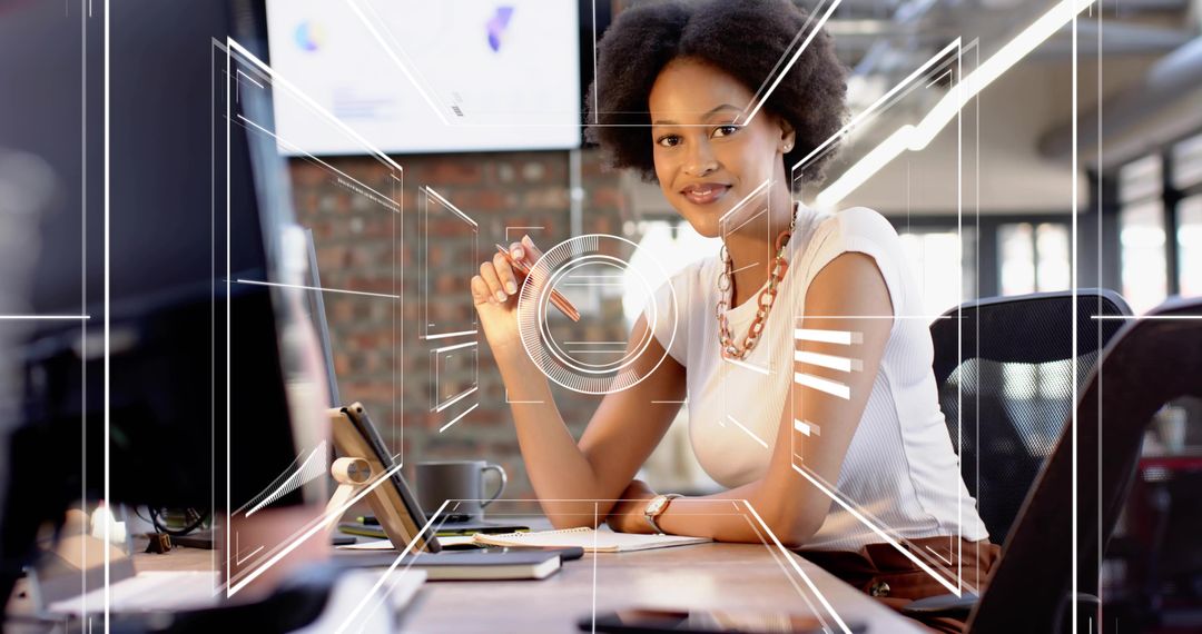Young professional woman working at modern desk with digital HUD overlays