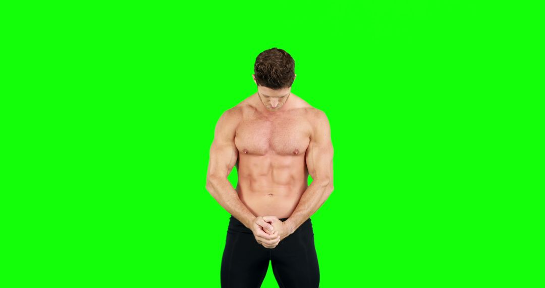 Muscular Shirtless Man in Black Pants Against Green Background - Free Images, Stock Photos and Pictures on Pikwizard.com