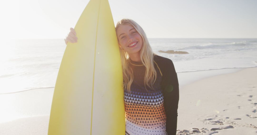 Smiling Blonde Woman with Surfboard on Sunny Beach - Free Images, Stock Photos and Pictures on Pikwizard.com