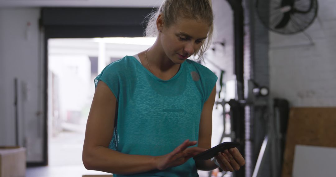 Female Worker Using Smartphone in Industrial Warehouse - Free Images, Stock Photos and Pictures on Pikwizard.com