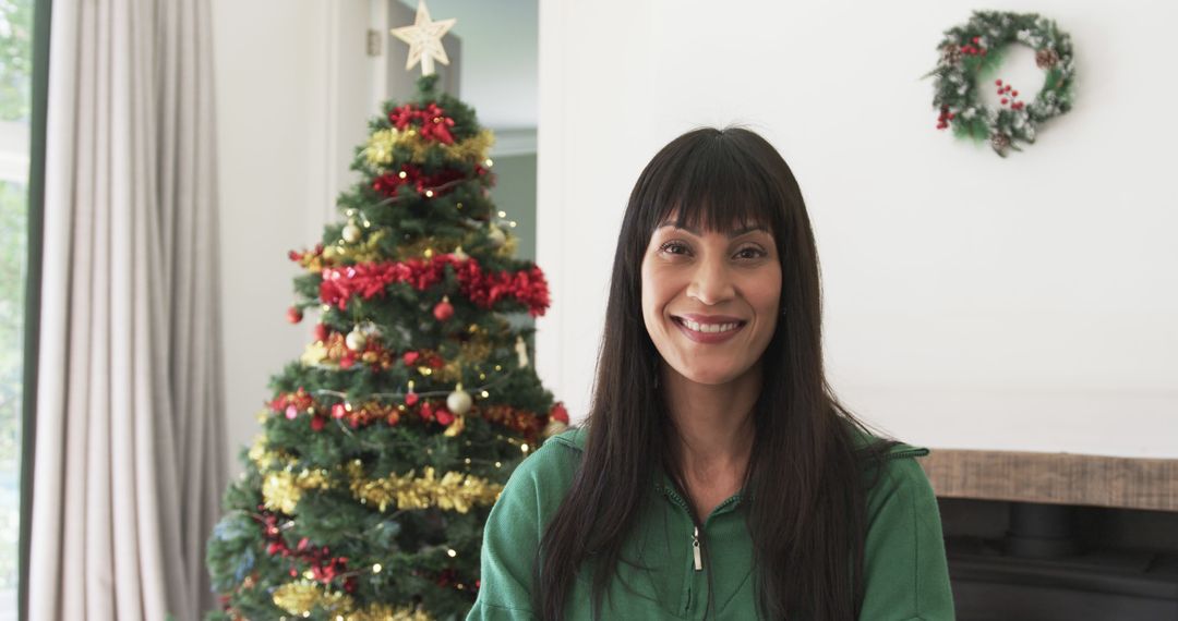 Portrait of happy biracial woman smiling by christmas tree at home, copy space, slow motion - Free Images, Stock Photos and Pictures on Pikwizard.com