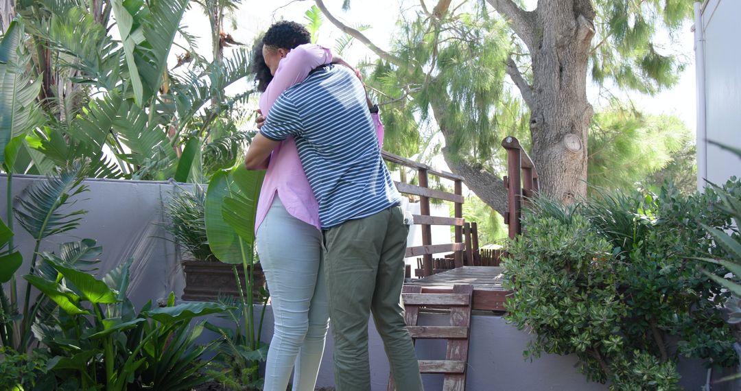 Young Couple Engaging in Romantic Proposal Amidst Lush Garden Setting