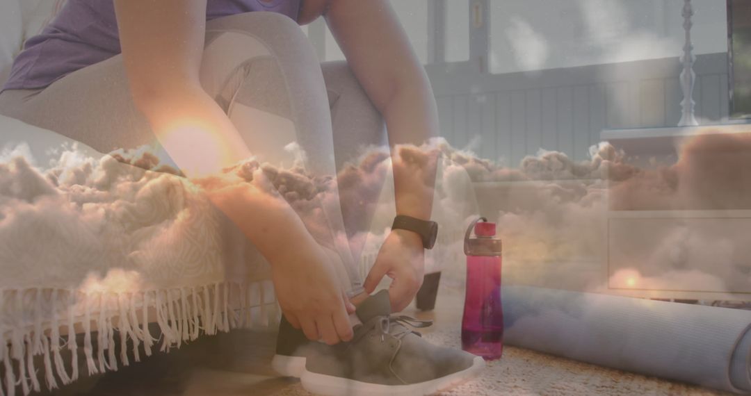 Woman Tying Shoe Laces Overlayed With Clouds Representing Active Lifestyle