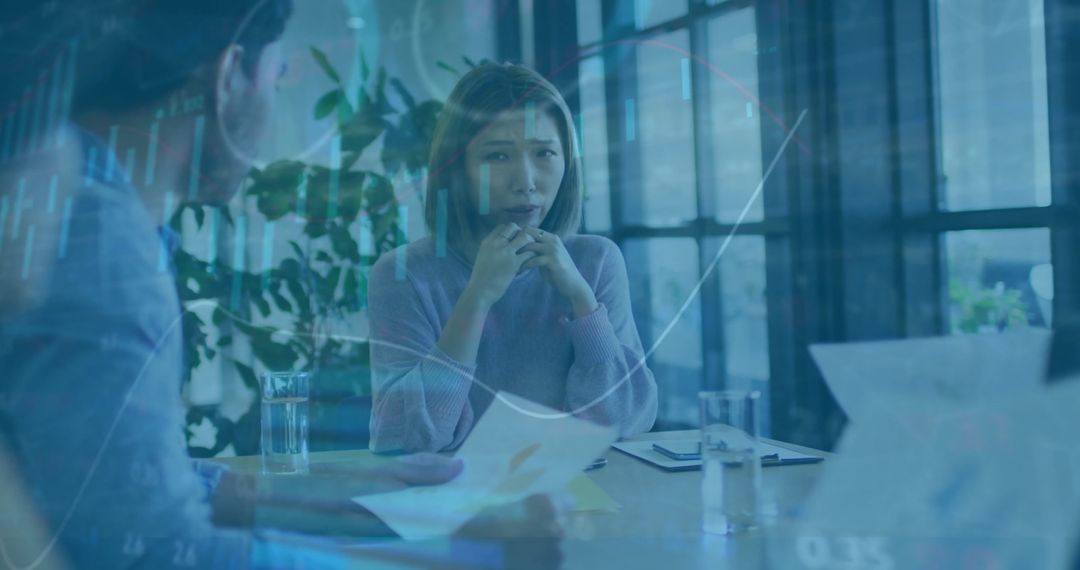 Business Team Analyzing Financial Data with Digital Interfaces