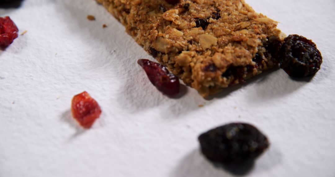 Close-Up of Granola Bar on White Surface with Berries - Free Images, Stock Photos and Pictures on Pikwizard.com