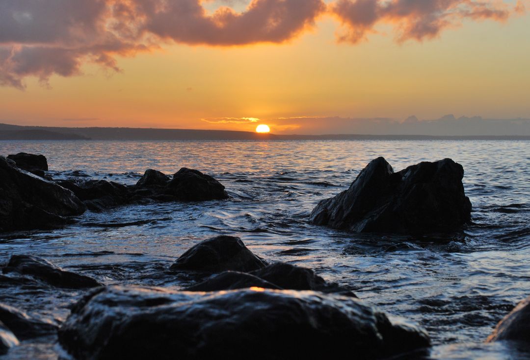 Dramatic Ocean Sunset Over Rocky Shoreline - Free Images, Stock Photos and Pictures on Pikwizard.com