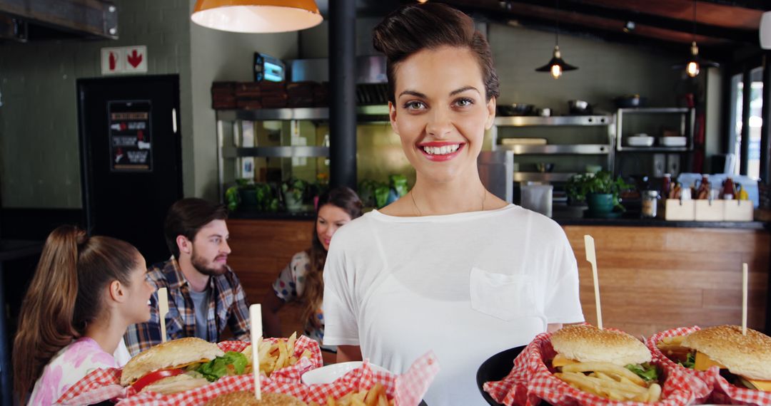 Smiling Waitress Serving Burgers in a Restaurant - Free Images, Stock Photos and Pictures on Pikwizard.com