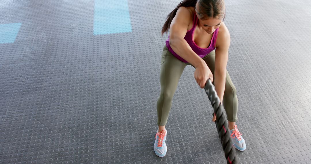 Woman Exercising with Battle Ropes in Gym from High Angle