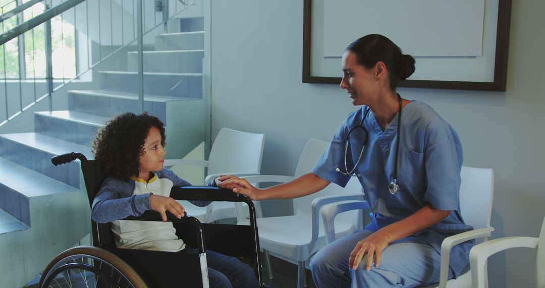 Nurse talking to child in wheelchair in modern clinic - Free Images, Stock Photos and Pictures on Pikwizard.com