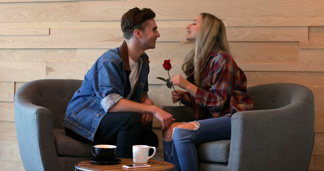 Young Couple Flirting in Cozy Café with a Rose and Coffee - Free Images, Stock Photos and Pictures on Pikwizard.com