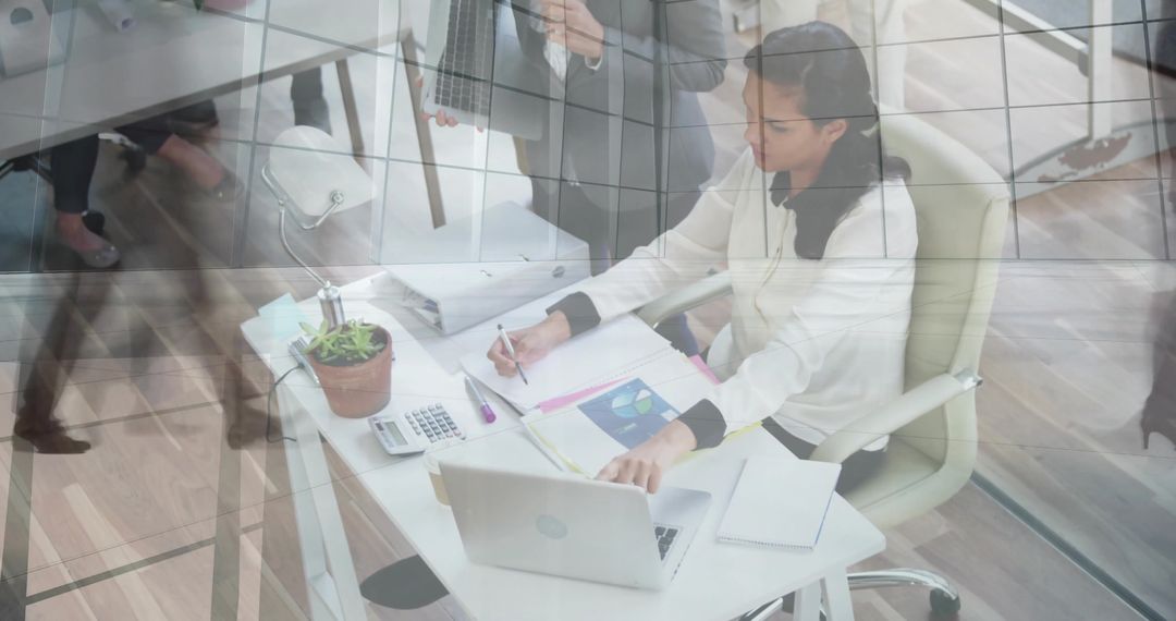 Middle Eastern Woman Analyzing Data in Modern Office