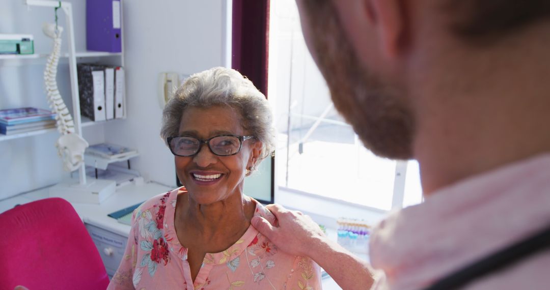 Senior woman smiling with doctor in clinic