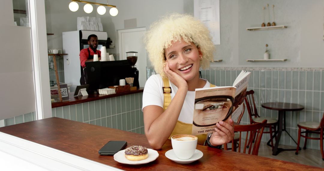 Smiling Woman Enjoying Coffee and Book in Modern Cafe