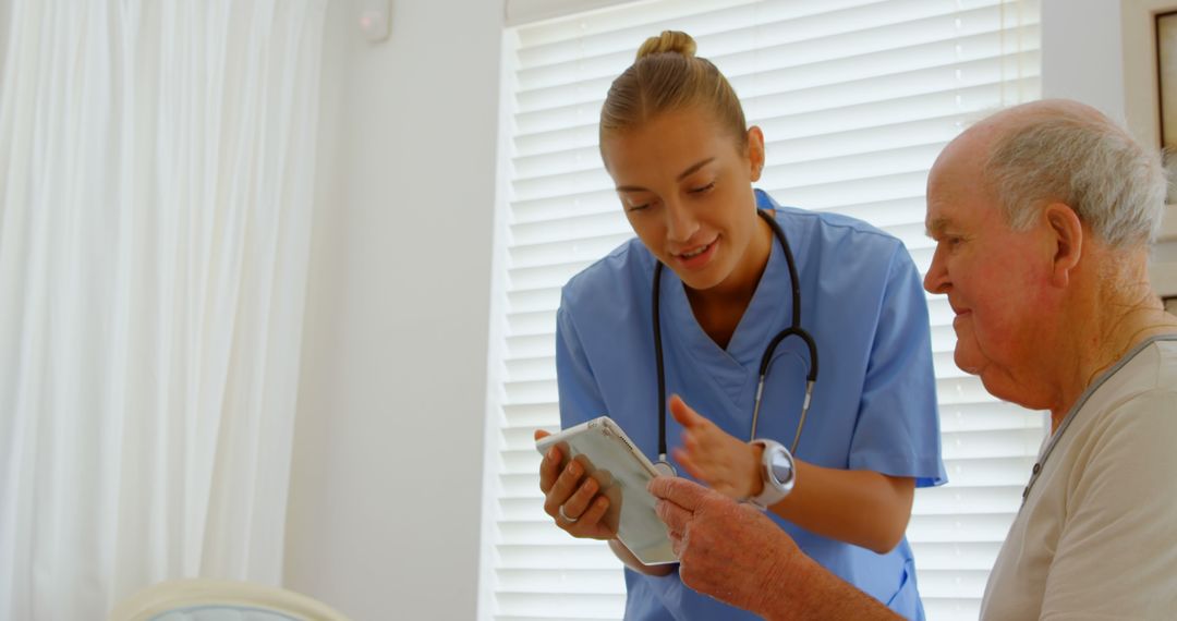 Healthcare Worker Assisting Elderly Man with Tablet Device for Telemedicine - Free Images, Stock Photos and Pictures on Pikwizard.com