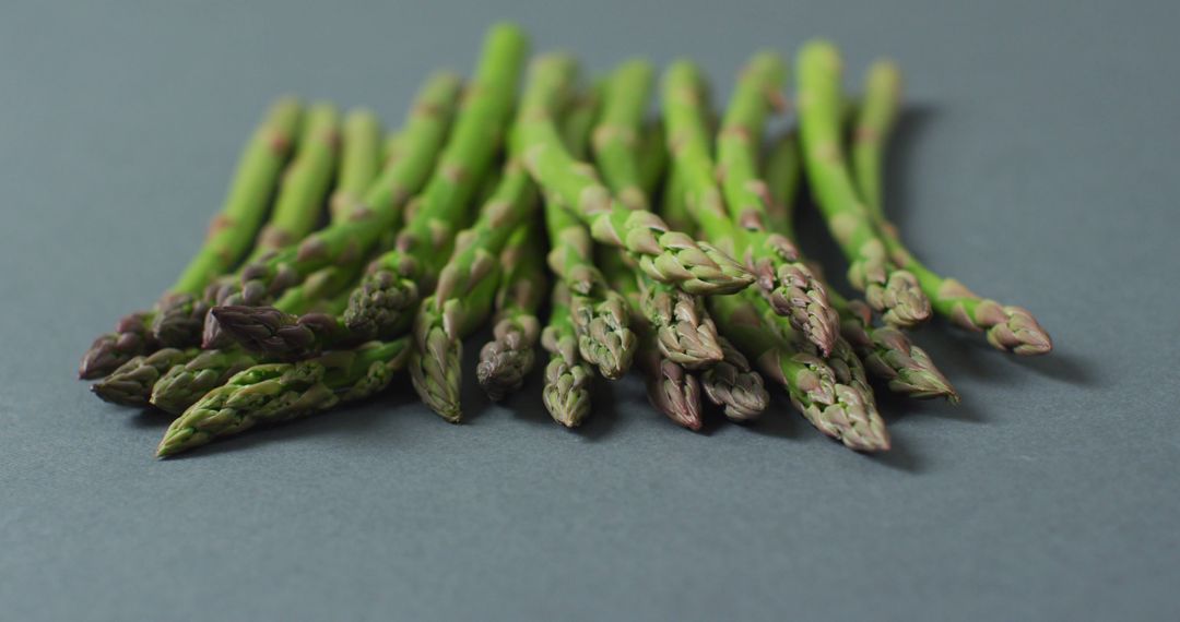 Image of close up of fresh asparagus over grey background - Free Images, Stock Photos and Pictures on Pikwizard.com