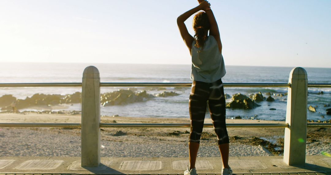 Woman Stretching by Oceanfront at Sunrise - Free Images, Stock Photos and Pictures on Pikwizard.com