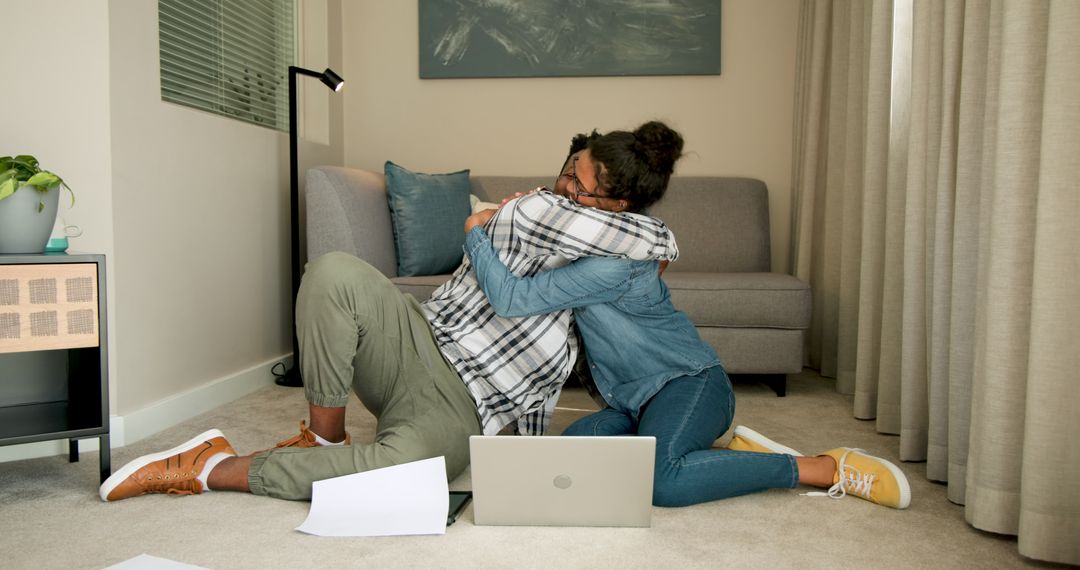 Couple Embracing on Floor with Laptop and Notebook, Relaxed Relationship Moment