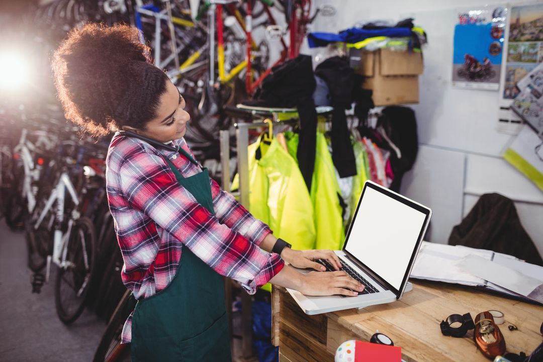 Bicycle Mechanic Multitasking on Computer and Phone