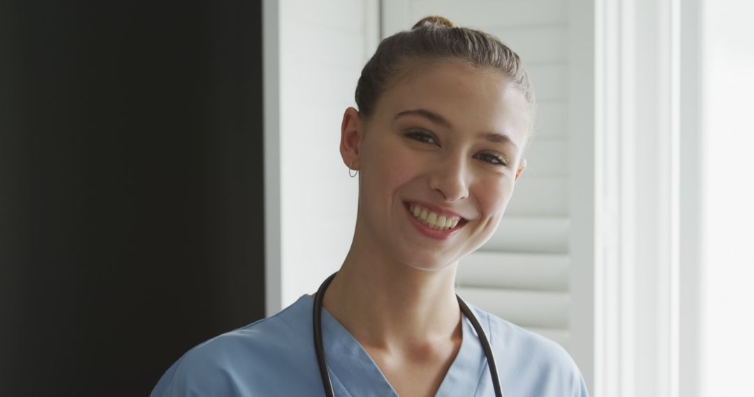 Smiling Female Nurse in Blue Scrubs with Stethoscope - Free Images, Stock Photos and Pictures on Pikwizard.com