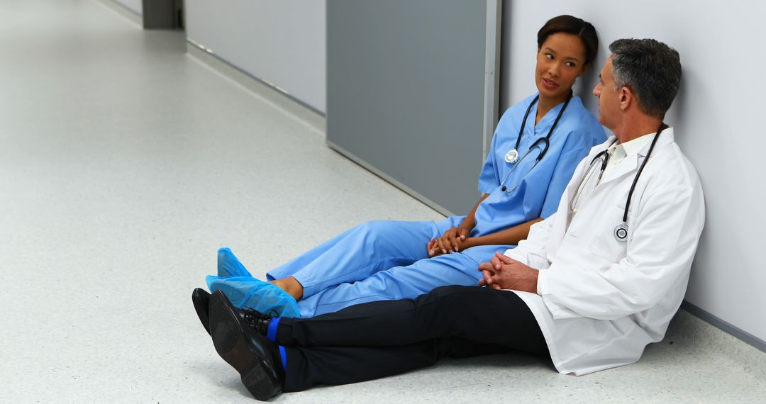 Healthcare Professionals Relaxing in Hospital Corridor - Free Images, Stock Photos and Pictures on Pikwizard.com