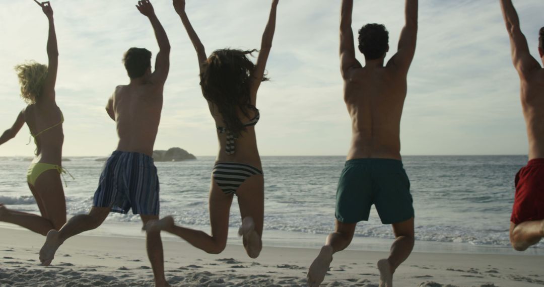 Group of Friends Jumping on Beach During Sunset - Free Images, Stock Photos and Pictures on Pikwizard.com