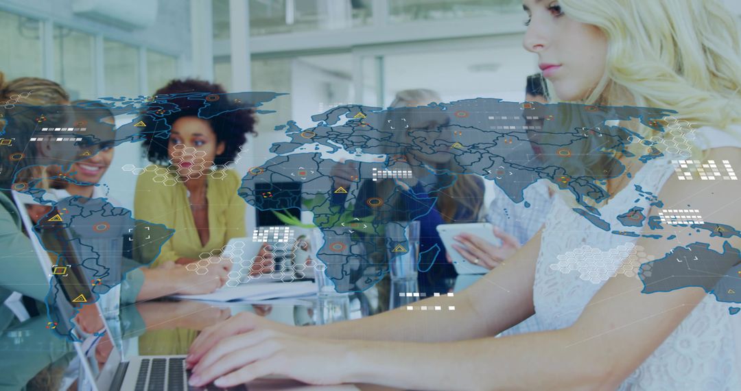 Typing woman working on laptop with translucent global data overlay in collaborative office
