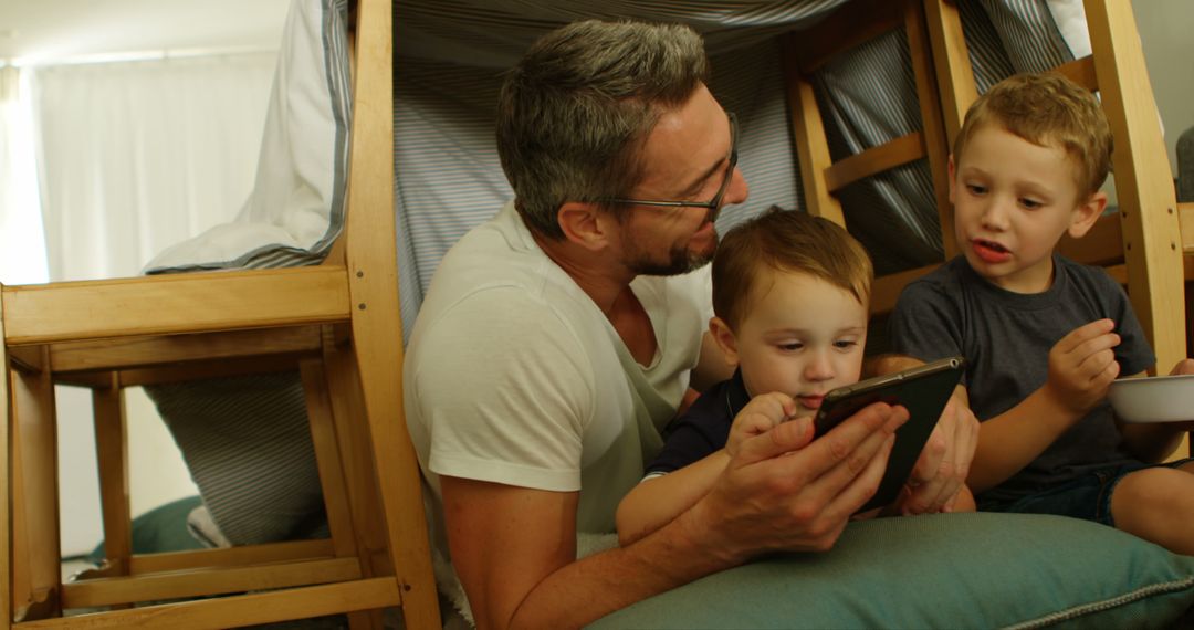 Father Reading to Sons Inside Indoor Tent - Free Images, Stock Photos and Pictures on Pikwizard.com