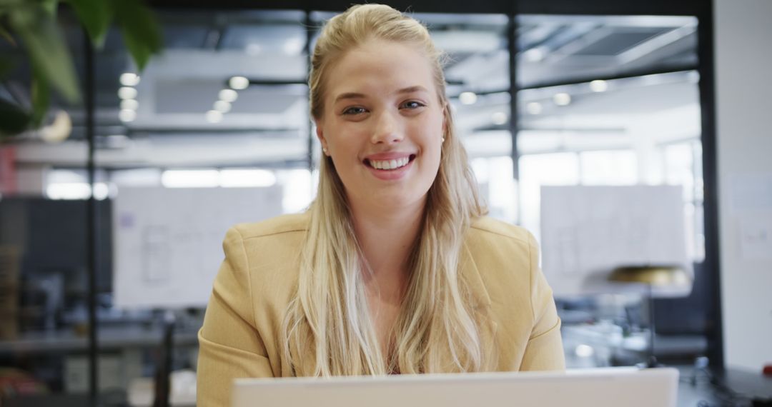 Young Professional Woman Smiling in Modern Office Environment - Free Images, Stock Photos and Pictures on Pikwizard.com