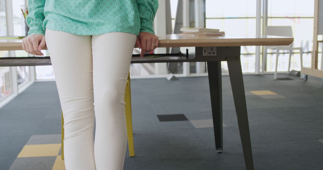 Woman Leaning on Desk in Modern Office Space - Free Images, Stock Photos and Pictures on Pikwizard.com