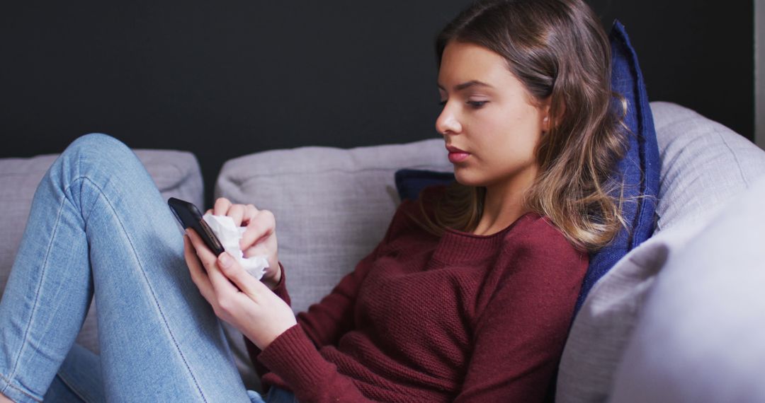 Teen Girl Using Smartphone on Sofa with Cozy Blanket - Free Images, Stock Photos and Pictures on Pikwizard.com