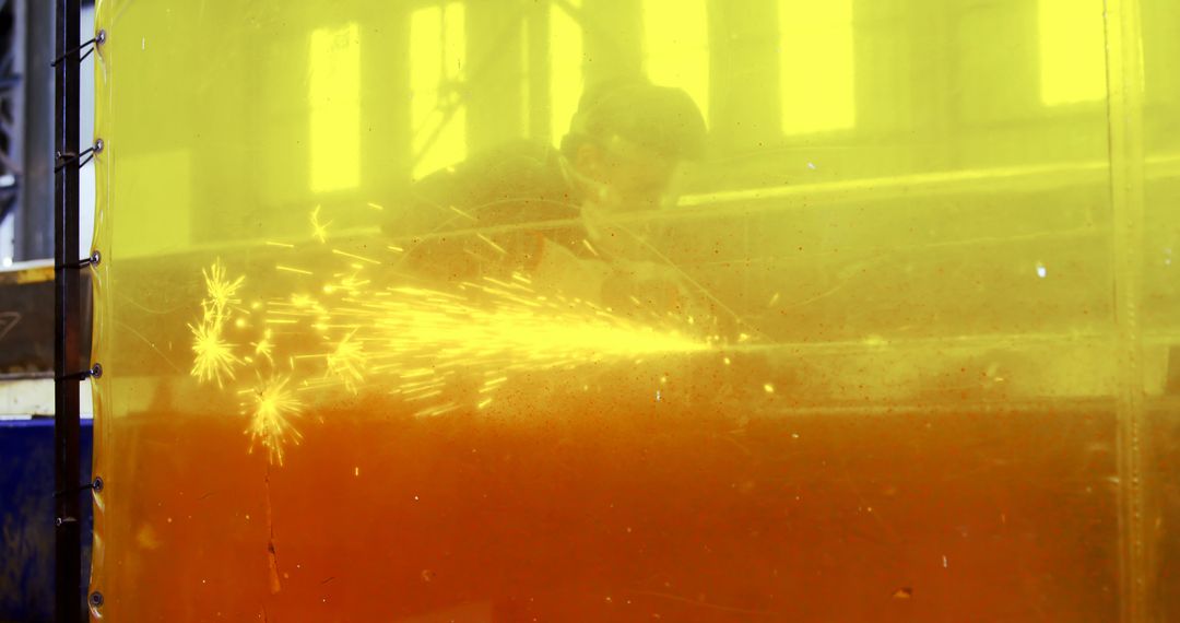 Industrial Worker Cutting Metal Safely Behind Barrier - Free Images, Stock Photos and Pictures on Pikwizard.com