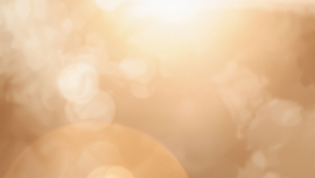 Golden Sun Halo with Orange Lens Flare and Soft Bokeh Abstract Background